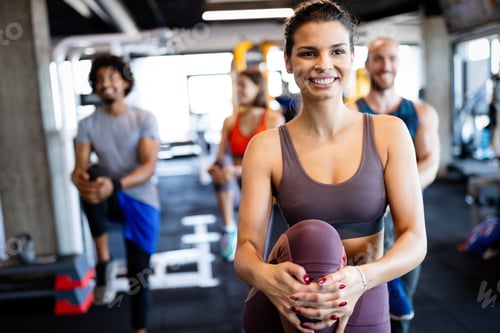 Preview: Beautiful fit people working out in gym together