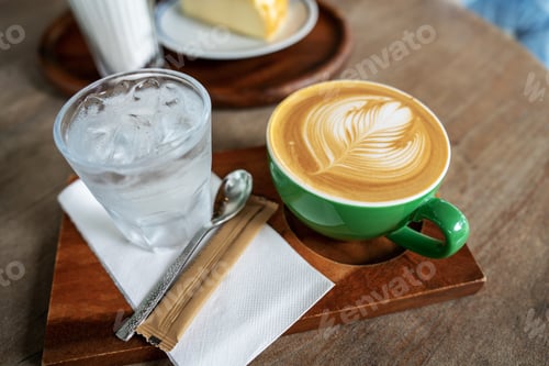 Preview: Hot coffee latte a cup of coffee cupucino on wood table background with warm morning sunlight