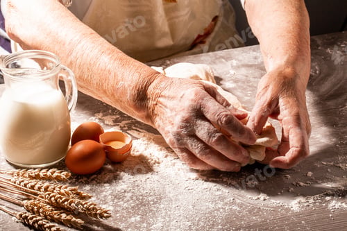Preview: Hands of granny kneads dough. 80 years old woman hands kneading dough. homemade baking