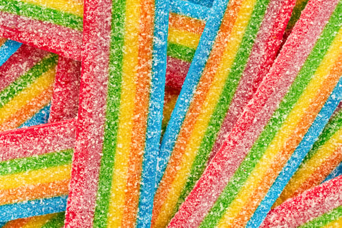 Preview: Colorful jelly candies in sugar sprinkles. Sour flavored rainbow candy background.