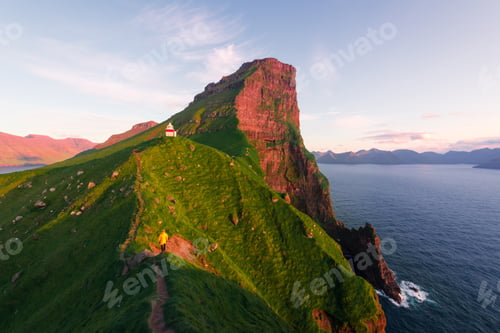 Preview: Kallur lighthouse on green hills of Kalsoy island