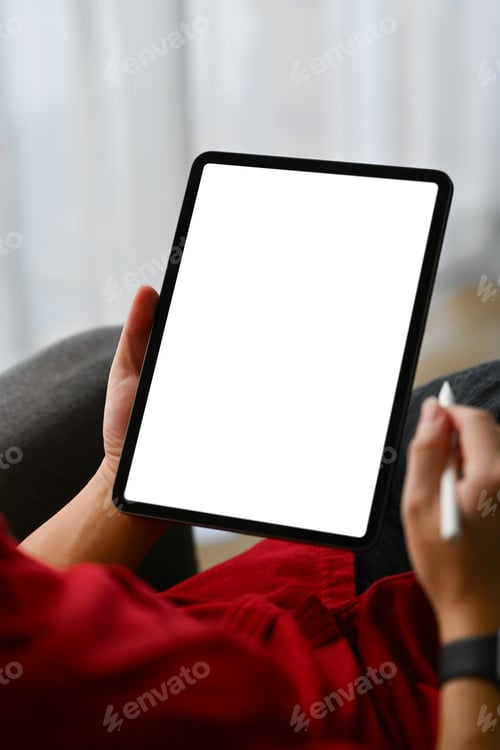 Preview: Close up shot creative male freelancer holding stylus pen using digital tablet on sofa