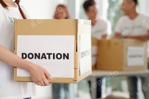 Preview: Volunteer holding cardboard box