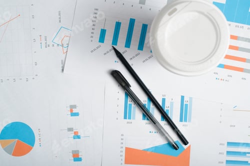 Preview: Top view disposable coffee cup, pencil, pen and business documents with financial figures,