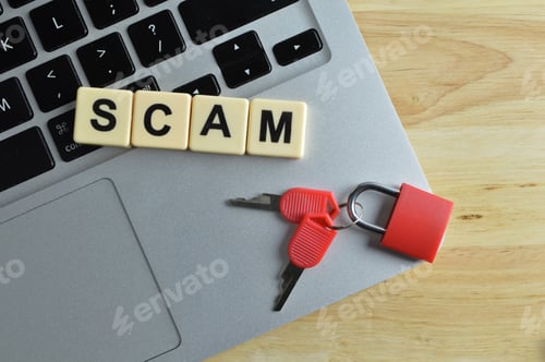 Preview: Top view of laptop, toy padlock, keys and scrabble letters with text SCAM.
