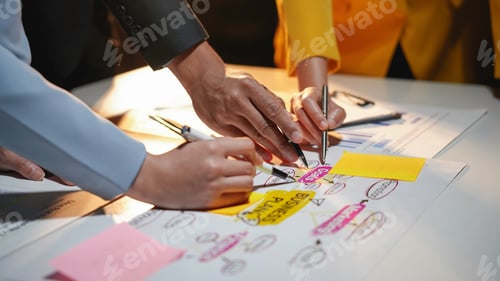 Preview: Business people using colorful sticky notes to create a business plan in a teamwork effort