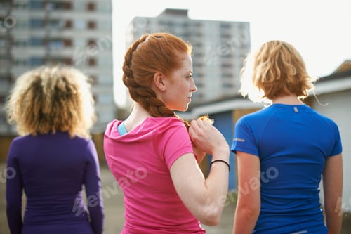 Preview: Rear view of three women standing together wearing sports clothing