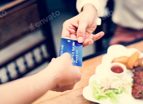 Preview: Woman paying lunch with credit card at restaurant