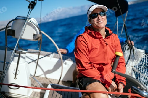 Preview: Attractive strong woman sailing with her boat