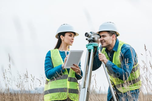 Preview: Surveyors working with digital level and tablet in field