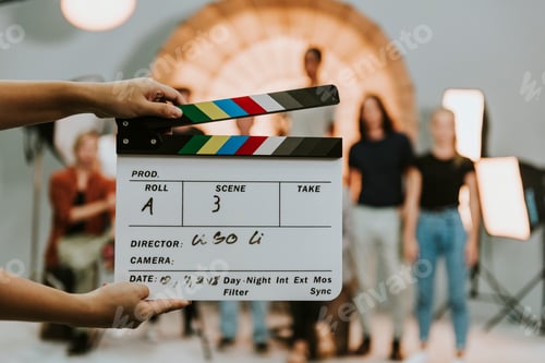 Preview: Woman holding a movie production clapperboard