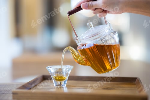 Preview: Tea pour into the glass of cup in the cafe shop