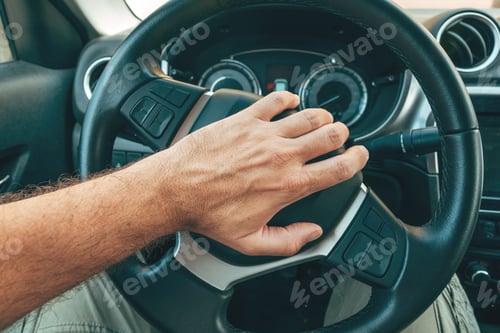 Preview: Angry and annoyed driver honking the car horn by pushing the button on steering wheel, pov image
