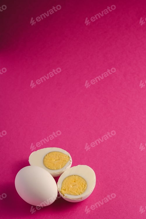 Preview: Boiled egg with yellow yolk near to white eggs