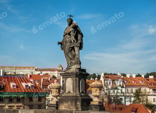 Preview: sculpture of Saint Anthony of Padua, against ancient roofs of Prague, Czech Republic