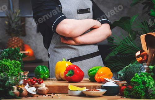 Preview: Chef confidently holds arms crossed over chest. Cooking food in the kitchen