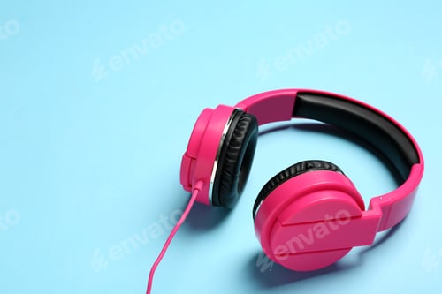 Preview: Stylish headphones on color background. Space for text