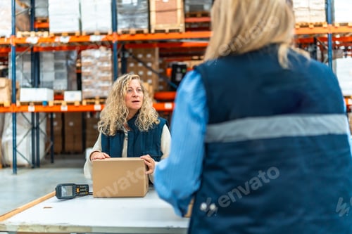 Preview: Women talking while preparing an order in a distribution warehouse