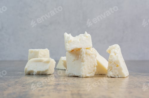 Preview: Slices of white cheese on marble table