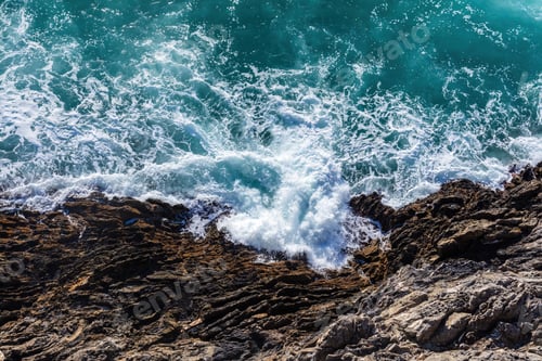 Preview: Waves crash and splash on rocks aerial top view