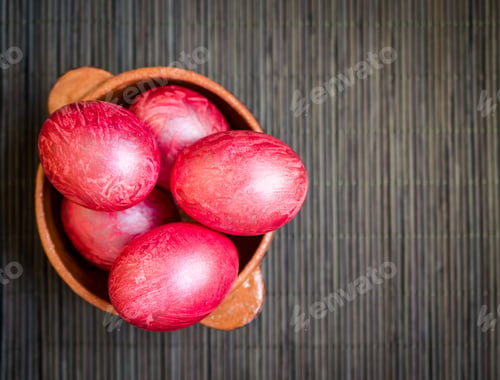 Preview: Colorful eggs in clay bowl