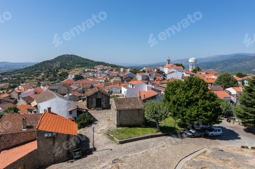 Preview: High angle view of the Belmonte surrounded by hills covered in greenery under sunlight in Portugal