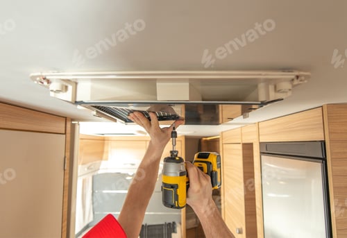 Preview: RV Technician Worker Replacing Air Conditioner Unit Inside Motorhome