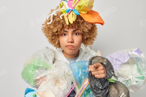 Preview: Serious environmental problem and ecology pollution. Attentive curly haired adult woman points index