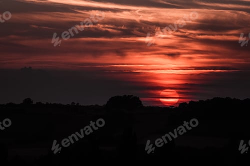 Preview: Dramatic red sunset in cloudy sky