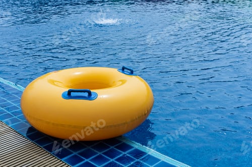 Preview: Yellow floating ring in swimming pool. Rubber ring swimming. Summer concept.