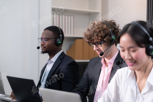 Preview: Group of business people wearing headset working actively in office.