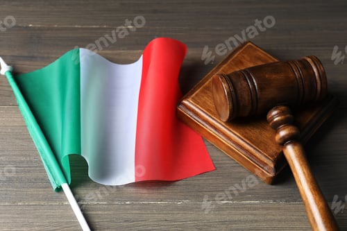 Preview: Judge's gavel and flag of Italy on wooden table, closeup