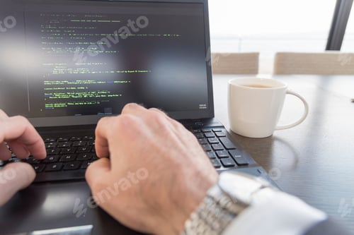 Preview: Point of view Business professional writing code at desk with coffee
