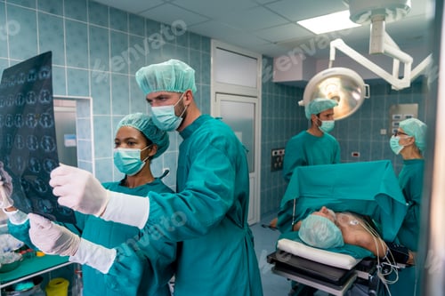 Preview: Surgeons Examining X-Ray Image in the Operating Room