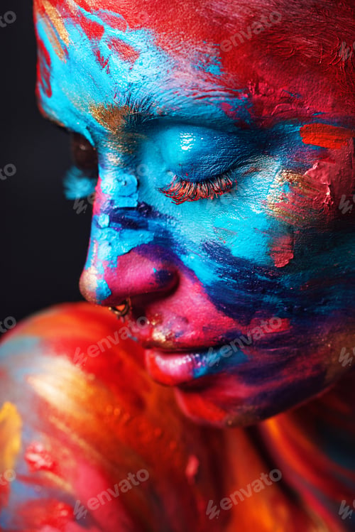 Preview: Shot of an attractive young woman posing alone in the studio with paint on her face