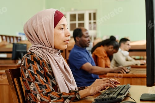 Preview: Muslim Woman Texting Something on Computer