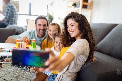 Preview: Happy young family take a self portrait with smart phone