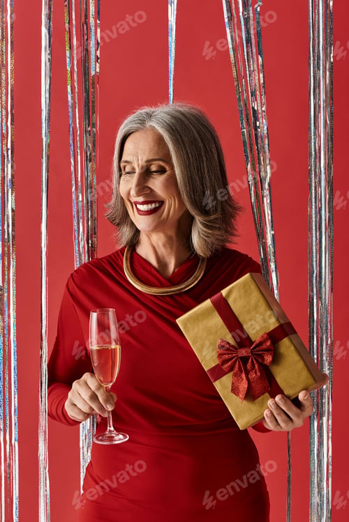 Preview: A joyful grey-haired woman celebrates Christmas and New Year with laughter and gifts