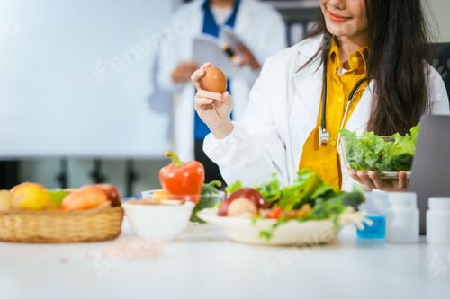 Preview: Two nutritionists,female and male, work in a hospital, analyzing vegetable and fruit salads