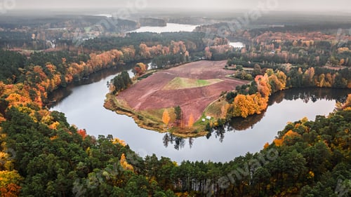 Preview: Dramatic view of winding river and autumn forest, aerial view