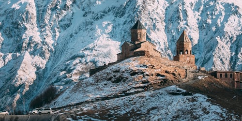 Preview: Stepantsminda, Georgia. Famous Gergeti Trinity Tsminda Sameba Church In Early Winter