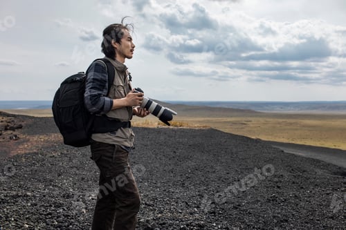 Preview: Chinese male photographer looking at view