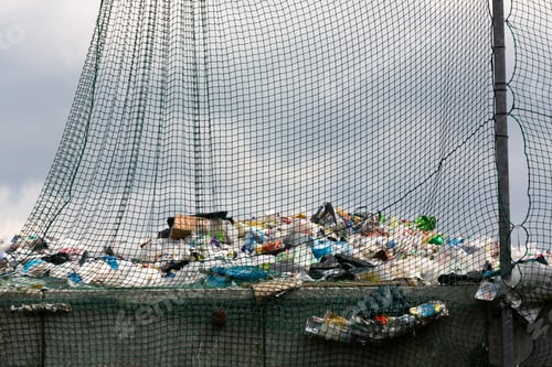 Preview: Packaging waste behind a net