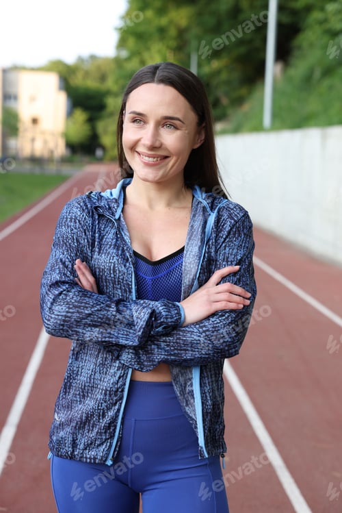 Preview: Happy woman in sportswear at stadium. Healthy lifestyle