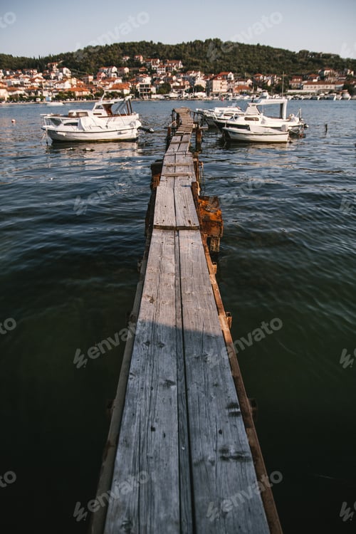 Preview: Wooden dock with boats near it