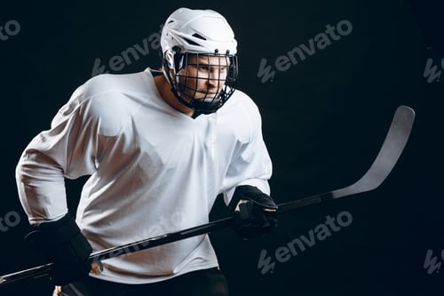 Preview: Image of ice-hockey player in white sportswear holding hockey stick