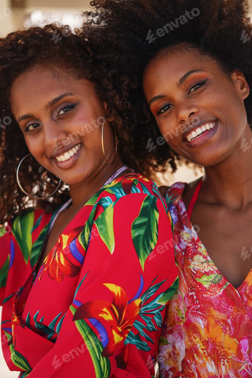 Preview: Two beautiful black women at the beach smiling