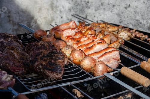 Preview: close up on a barbecue grill full of meat and onions, brazilian style