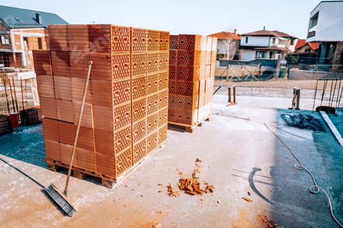 Preview: details of modern bricks on construction site. Piles of bricks on concrete slab.