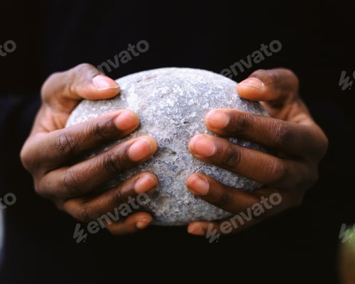 Preview: A man holding an oval stone